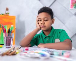 boy-sitting-table-looking-pensively-his-drawing (2) (1)